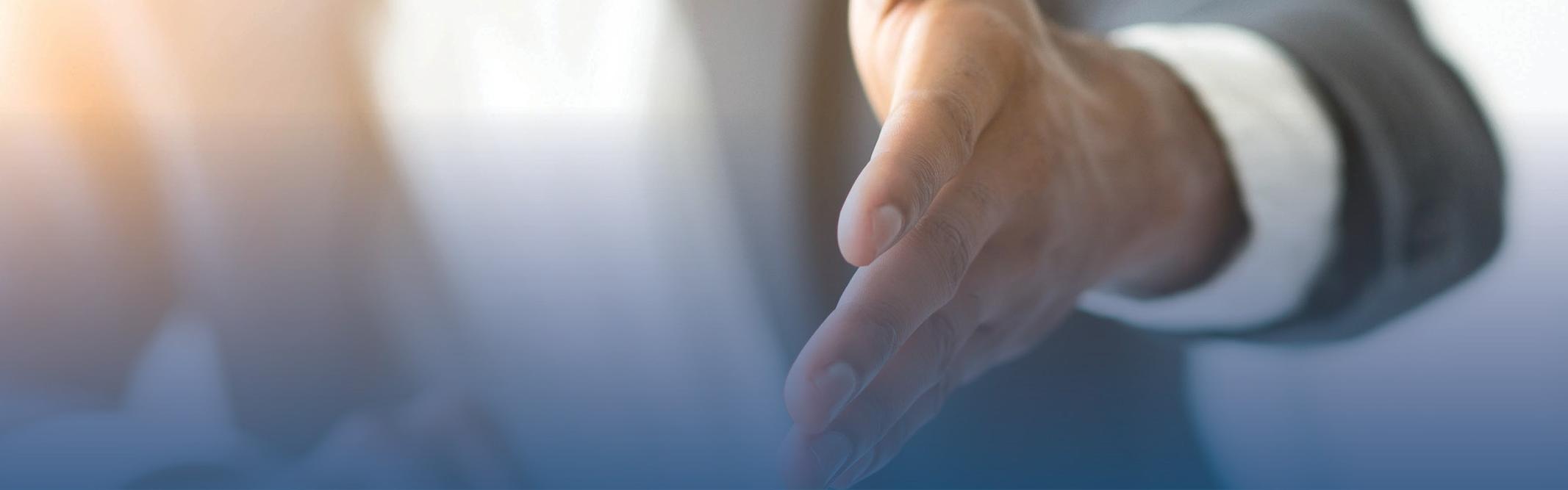 Man in suit extending hand out