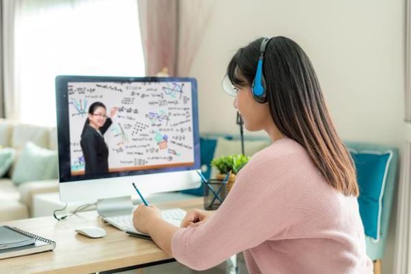 female at study desk with computer