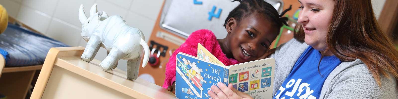 teacher with child and book